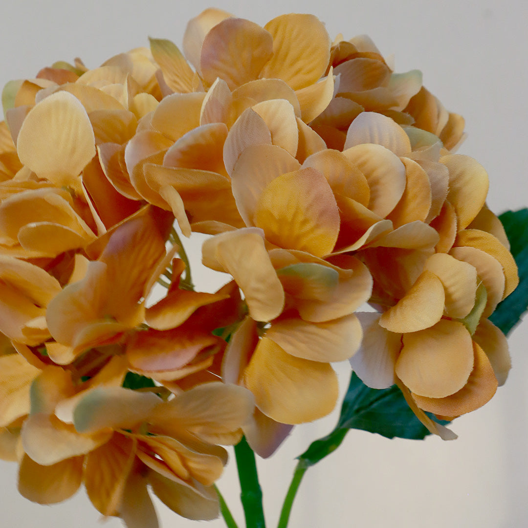 An artificial single flower stem with peach-orange clustered blossoms and green leaves on a long stem, isolated on a white background. Hydrangea X1 - Autumn Flower - Accessories | Vinoti Living